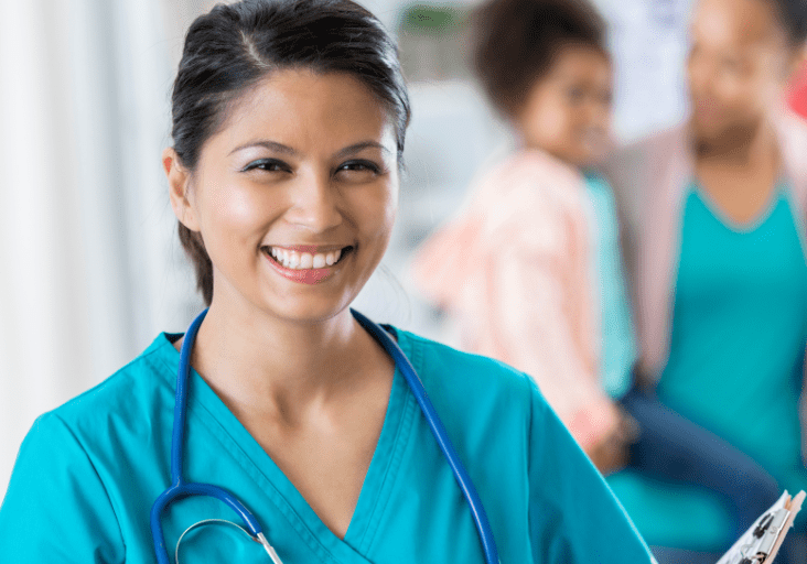 smiling nurse family in background