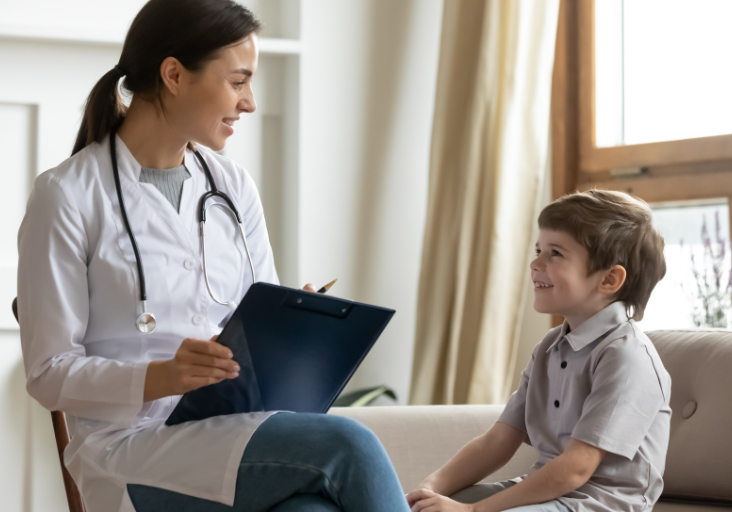 female doctor with boy smiling